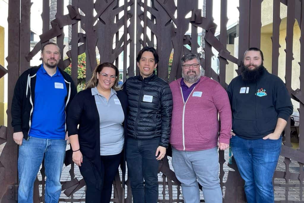 Group of people standing in front of gate