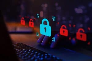 A hand touching a keyboard with a lock icon