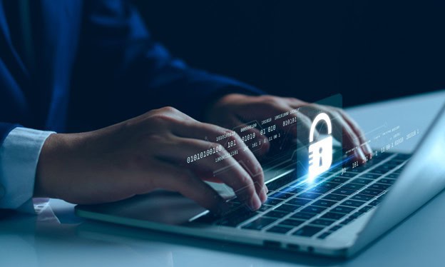 person typing on laptop with credit card information